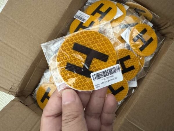 Close view of a labeled H sticker sleeve and packaged pieces