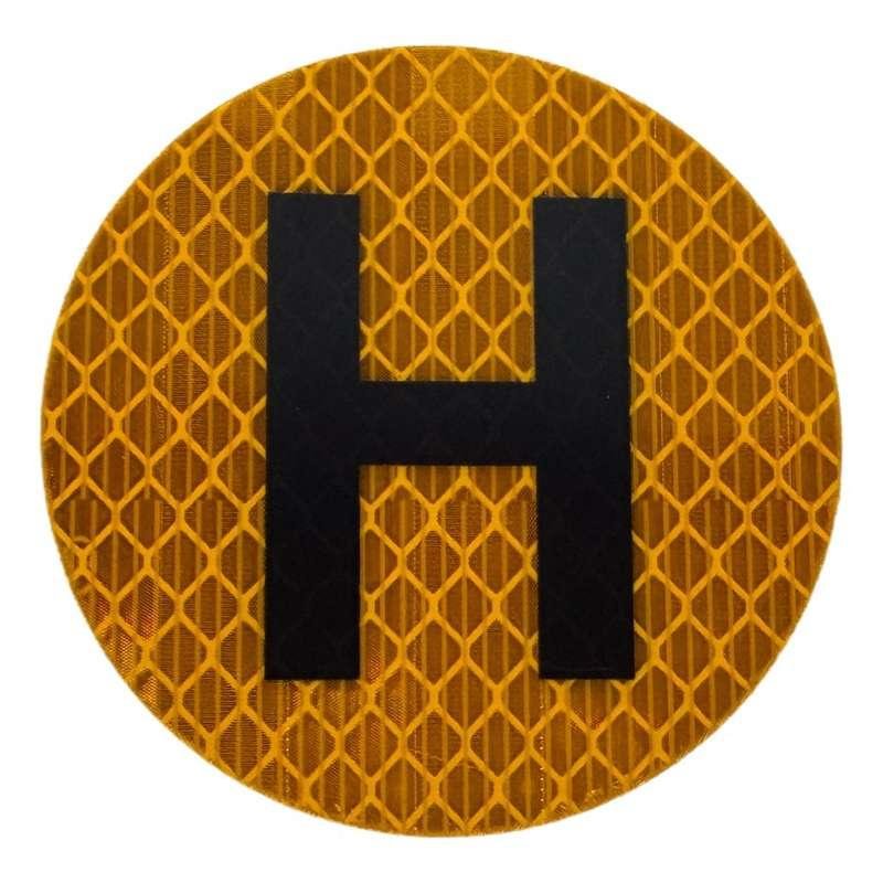 Round yellow reflective sticker with bold black H