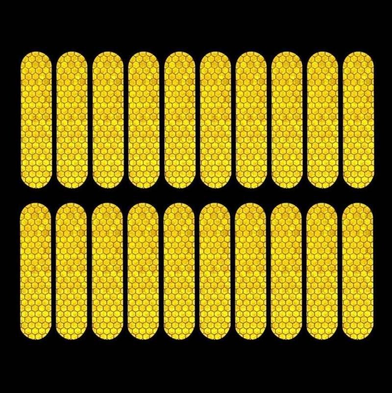 Twenty yellow reflective strips shown under directed illumination