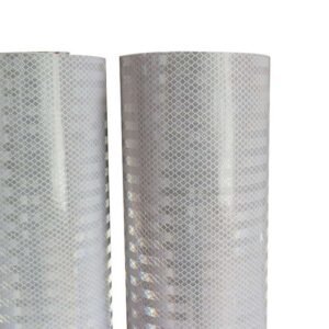 Close-up of the white reflective surface pattern on two PVC banner material rolls