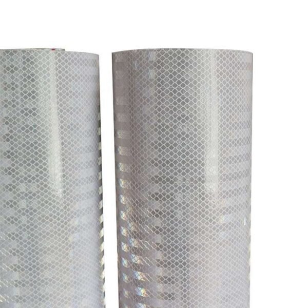 Close-up of the white reflective surface pattern on two PVC banner material rolls