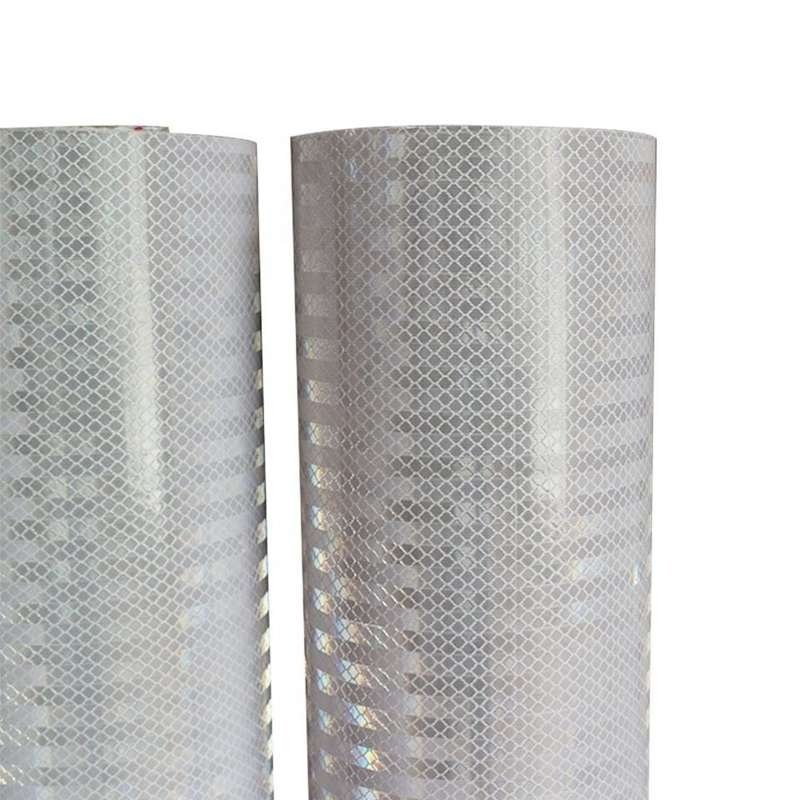 Close-up of the white reflective surface pattern on two PVC banner material rolls