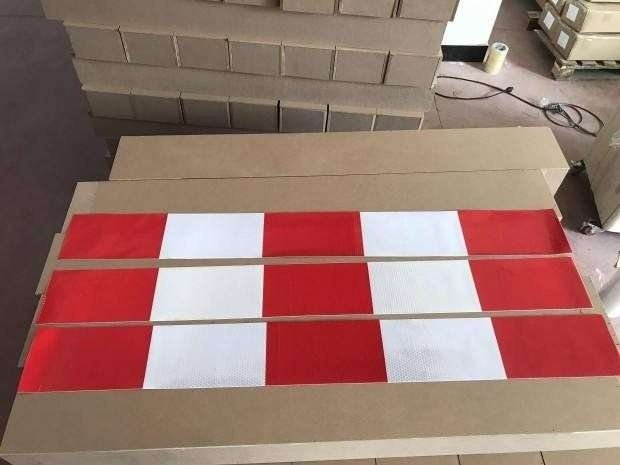 Red and white reflective barrier strips shown in full lengths