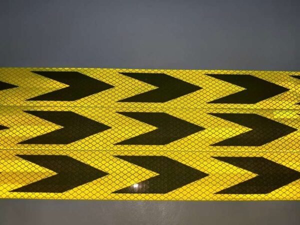 Close-up of black arrows and microprismatic reflective texture