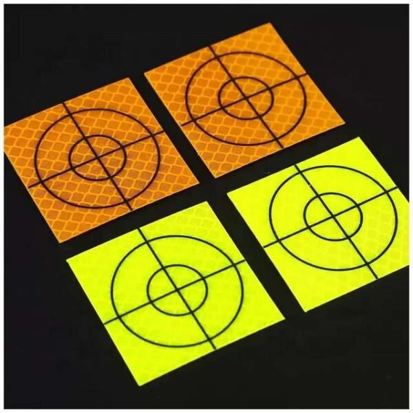 Orange and fluorescent yellow reflective survey targets with black crosshair markings