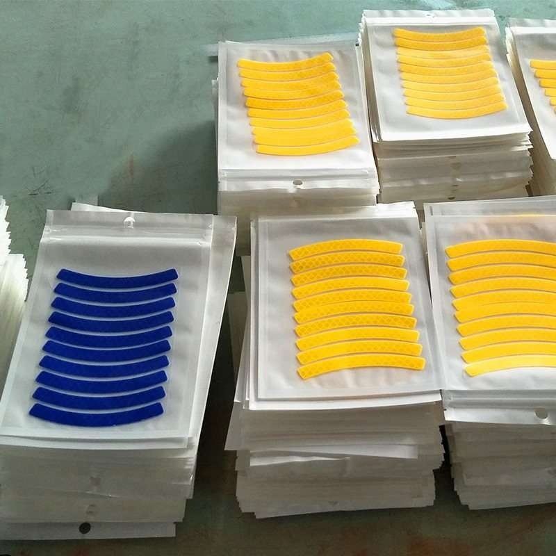 Packaged curved reflective wheel rim sticker sheets