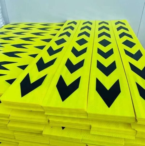 Fluorescent yellow and black directional arrow strips stacked for supply
