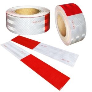 Red and white prismatic vehicle tape rolls and cut strips
