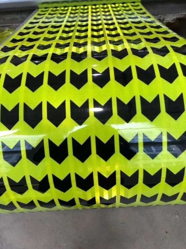 Unrolled reflective sheet showing repeated black arrows
