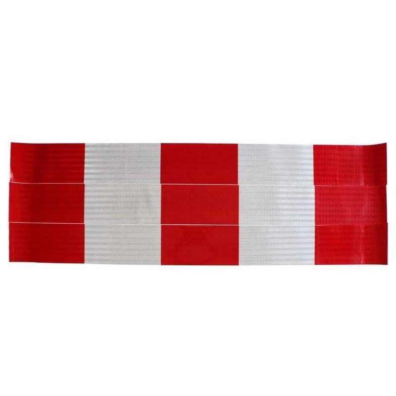 Red and white reflective barrier strips laid flat