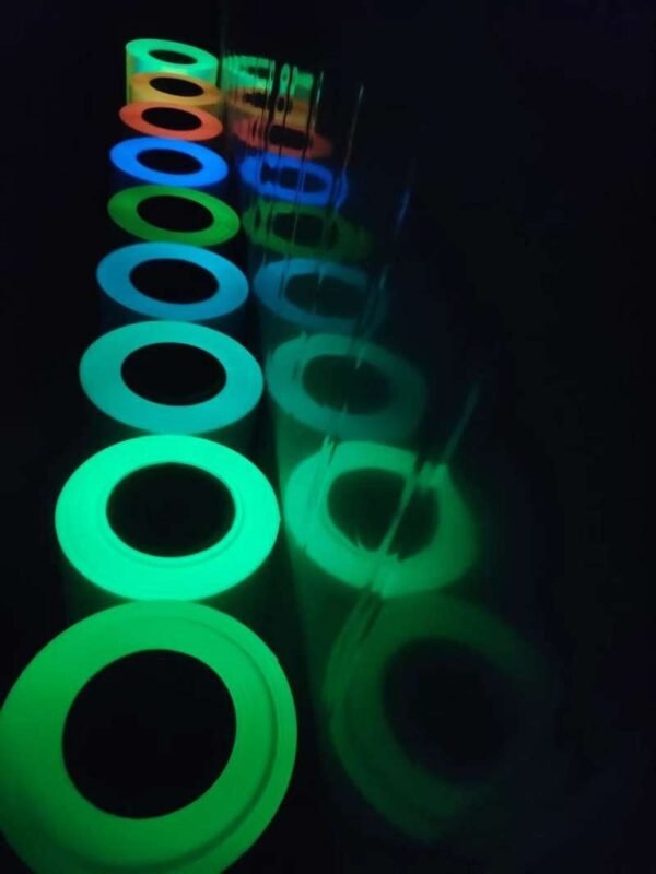 Top view of luminous vinyl rolls glowing in dark conditions