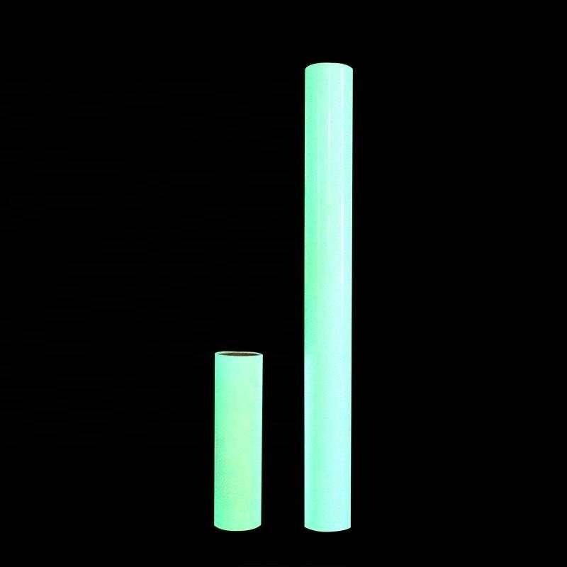 Two widths of photoluminescent film rolls glowing green