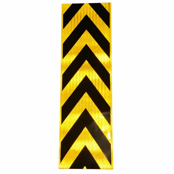 Single yellow and black arrow sticker showing reflective appearance under incident light