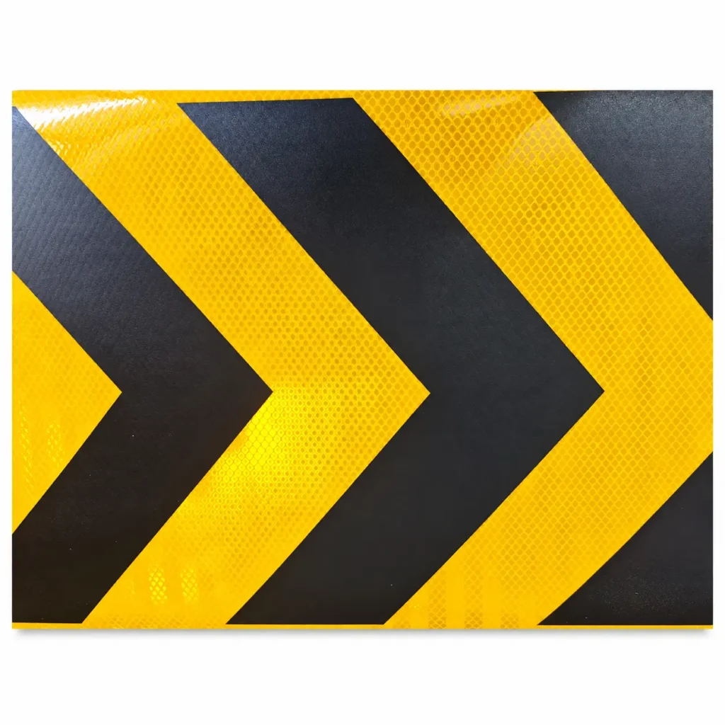 Close-up of black UV-printed arrows and yellow reflective surface texture